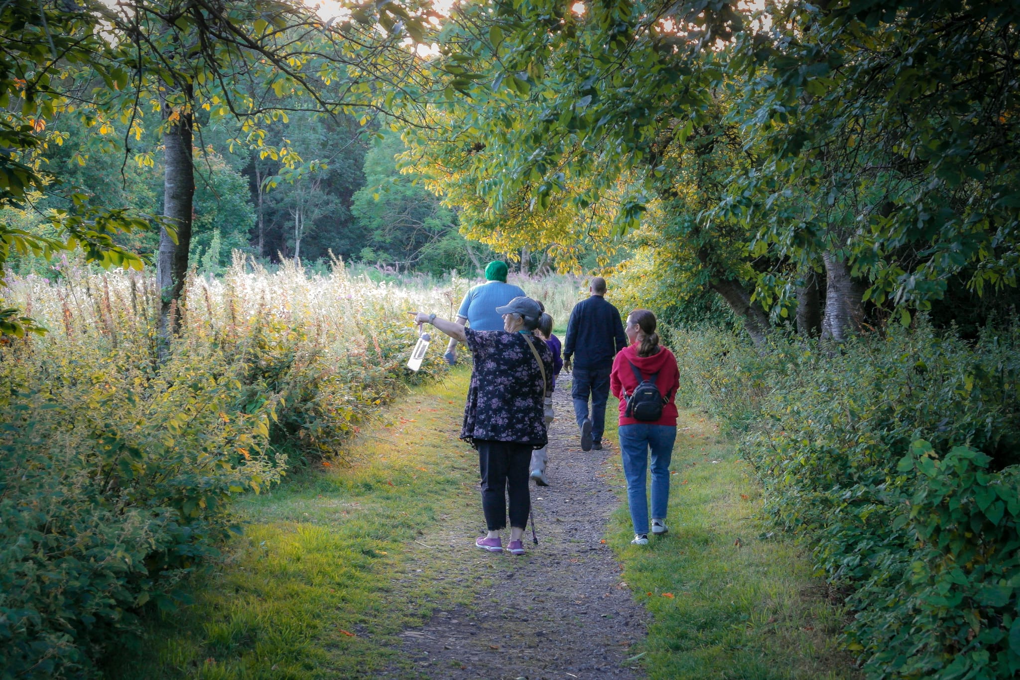 A wellbeing walking group outdoors on a nature trail in Calderdale